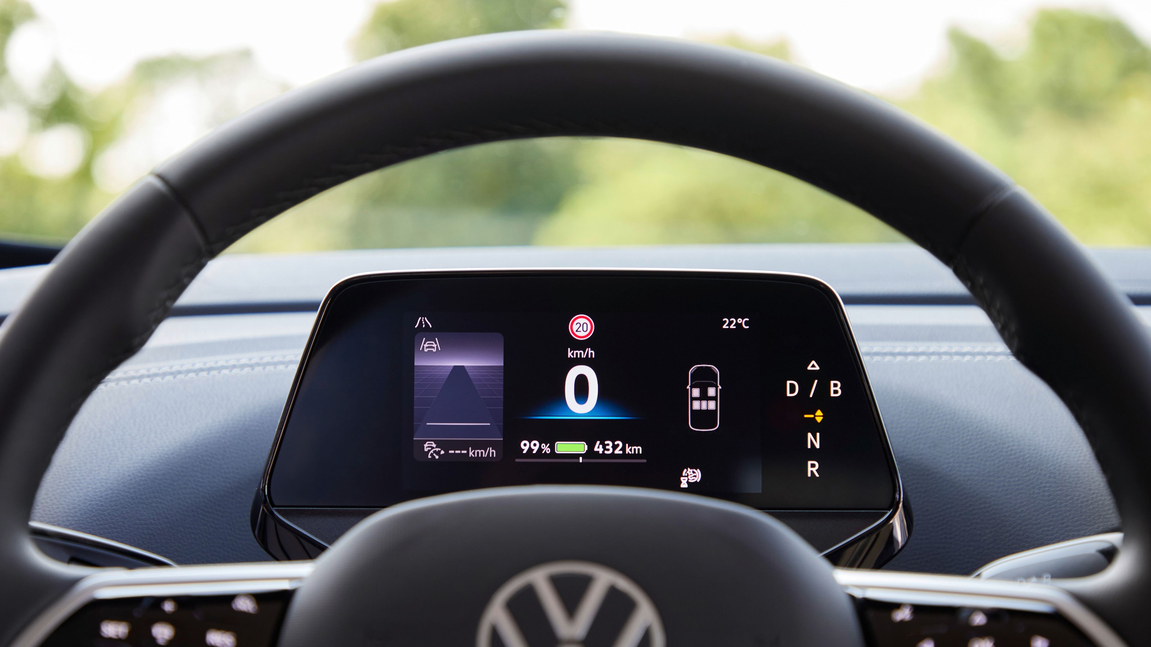 A close up of Volkswagen logo steering wheel and meter panel showing speed and car information of Volkswagen ID.5 