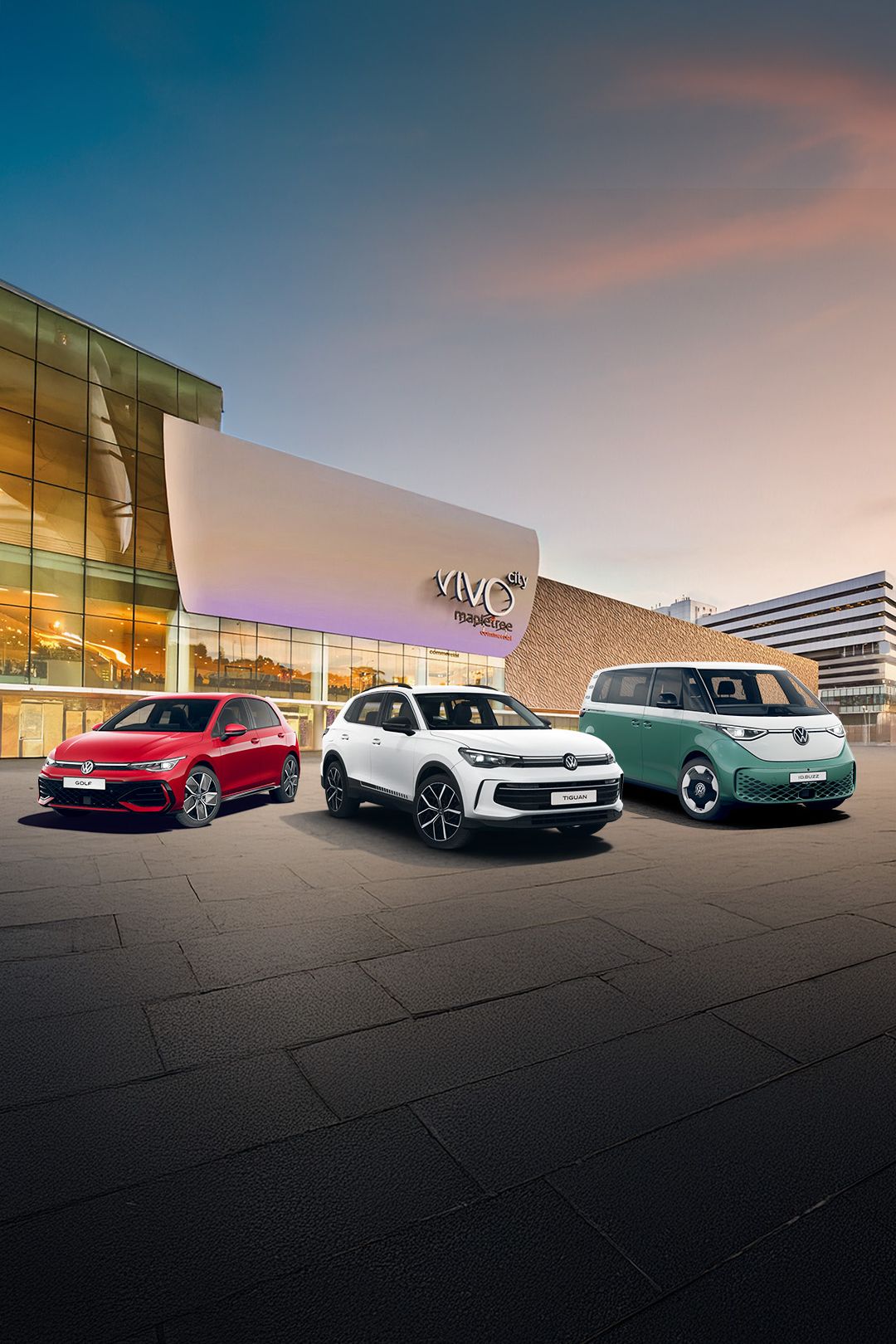 A red Golf, white Tiguan and a candy white and green ID. Buzz parked in front of the VivoCity facade