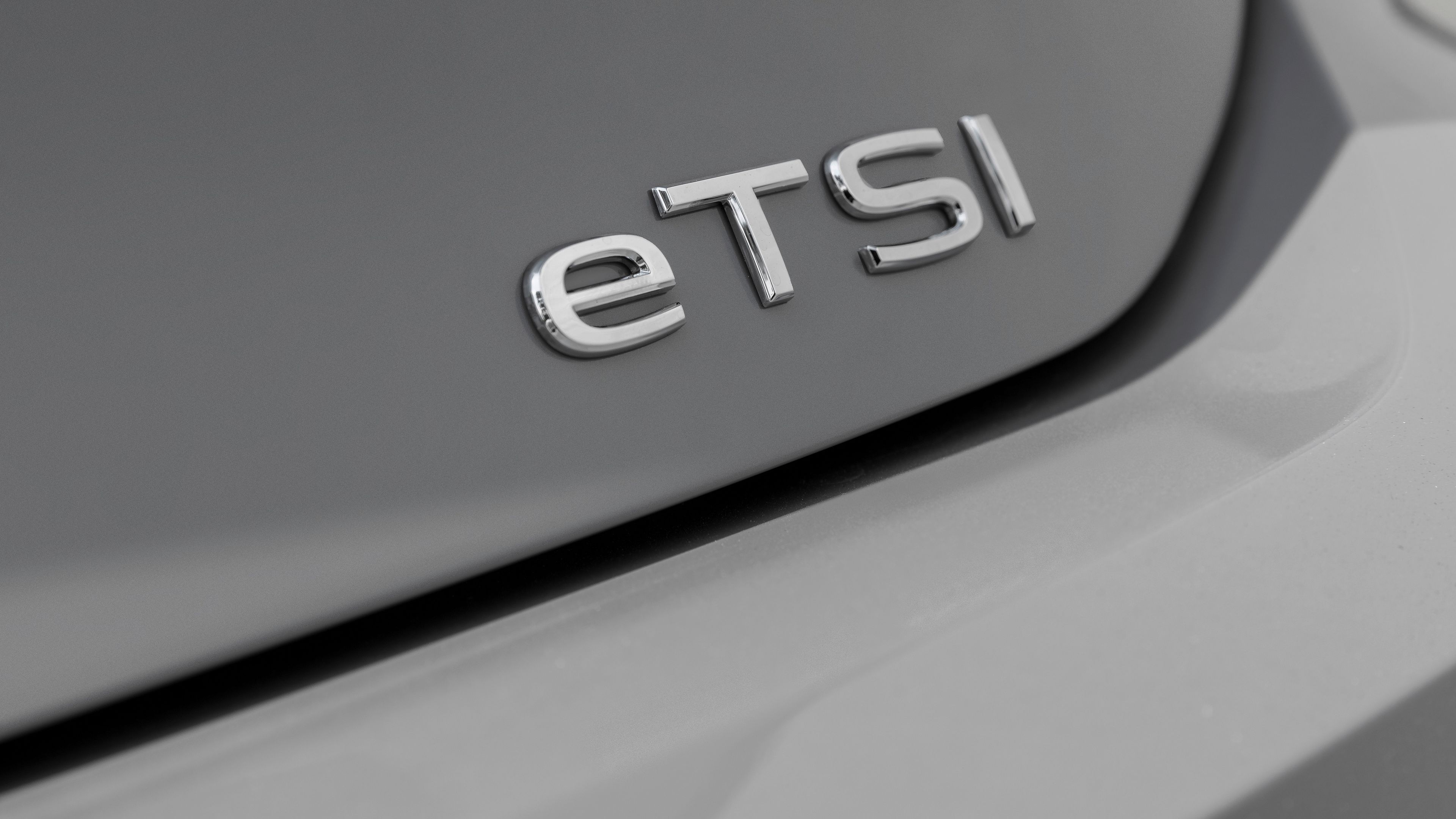 A close-up look of the exterior of a Volkswagen vehicle featuring the eTSI badge on the corner of its trunk.