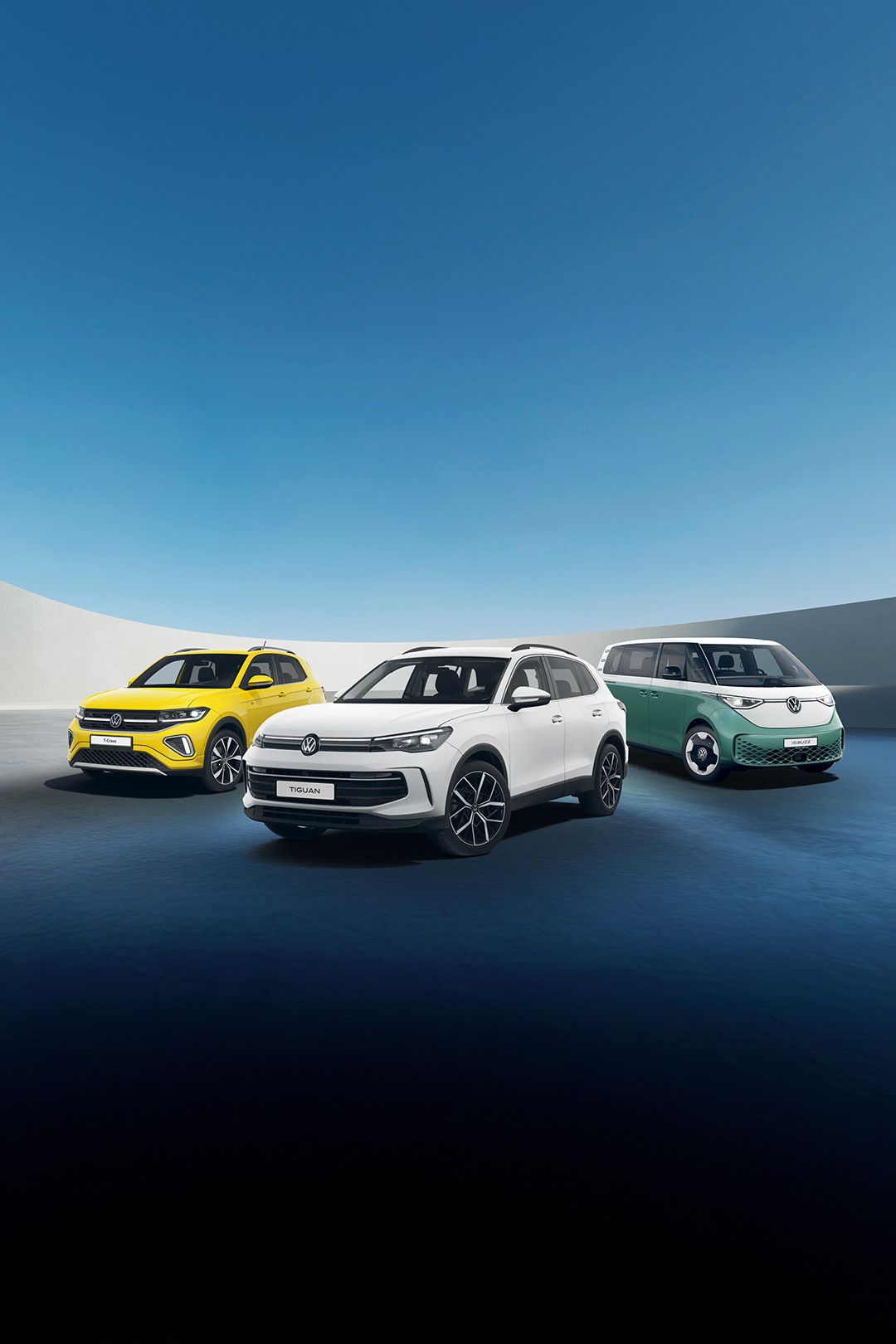 A white Tiguan, yellow T-Cross and candy white green ID. Buzz against a futuristic parking spot