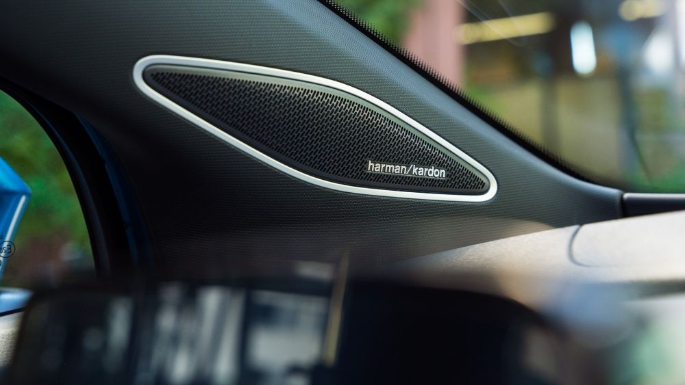 A speaker with "Harman Kardon" logo in a Volkswagen vehicle.