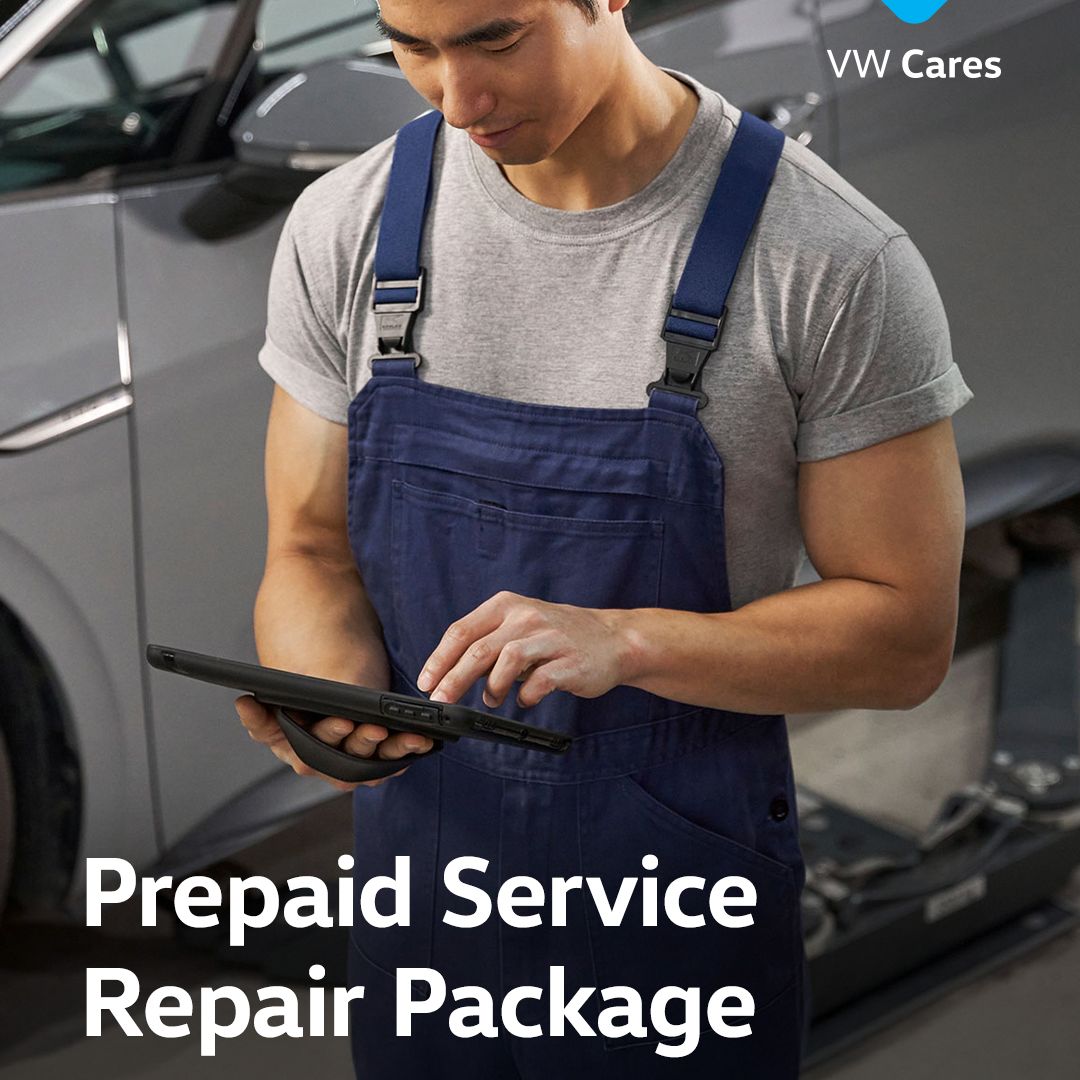A Volkswagen technician expert reviewing his tablet