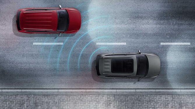 The rear traffic alert system detecting that a red vehicle is on the side.