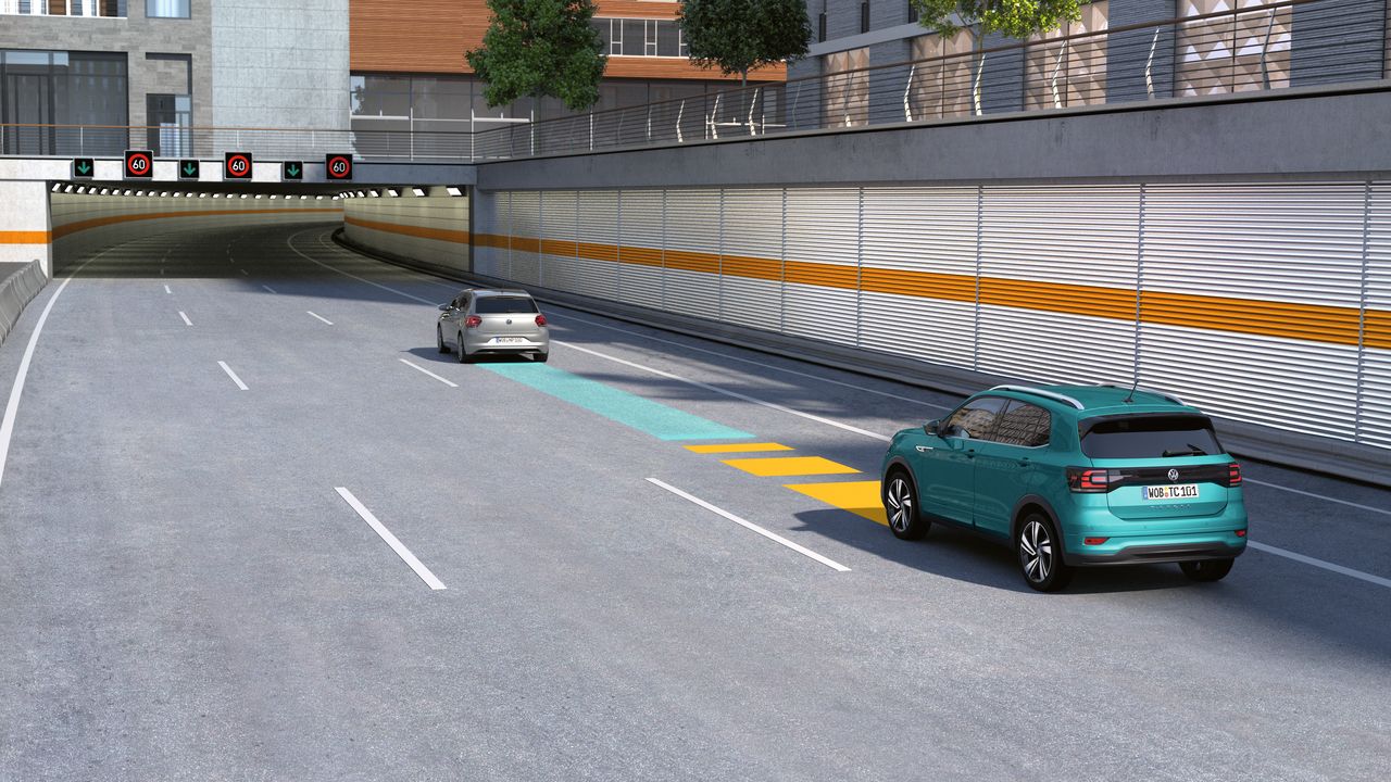 An image depicting a bright green Volkswagen vehicle trailing behind another vehicle at a safe distance on a highway.