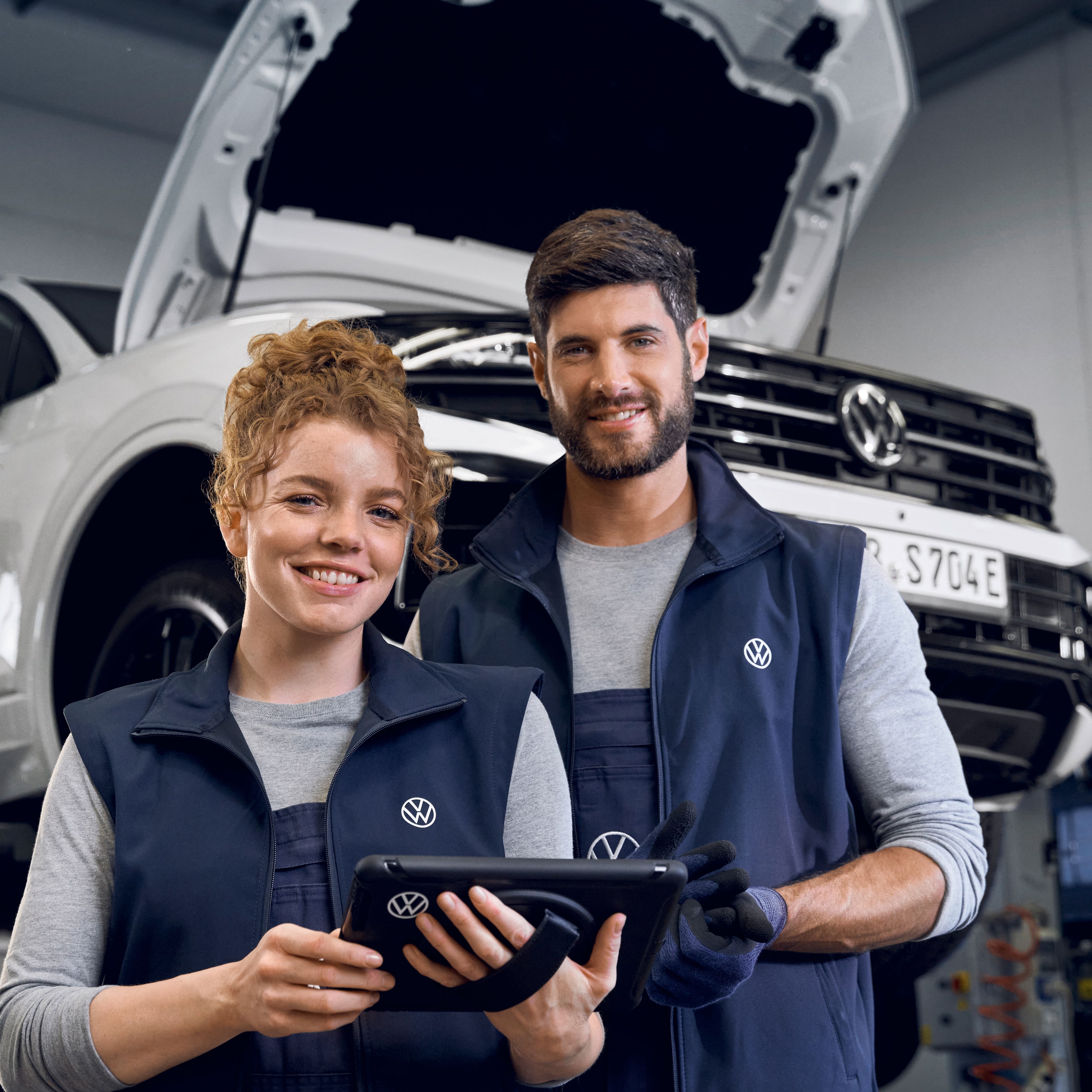 Two Volkswagen technician welcoming you to the service area