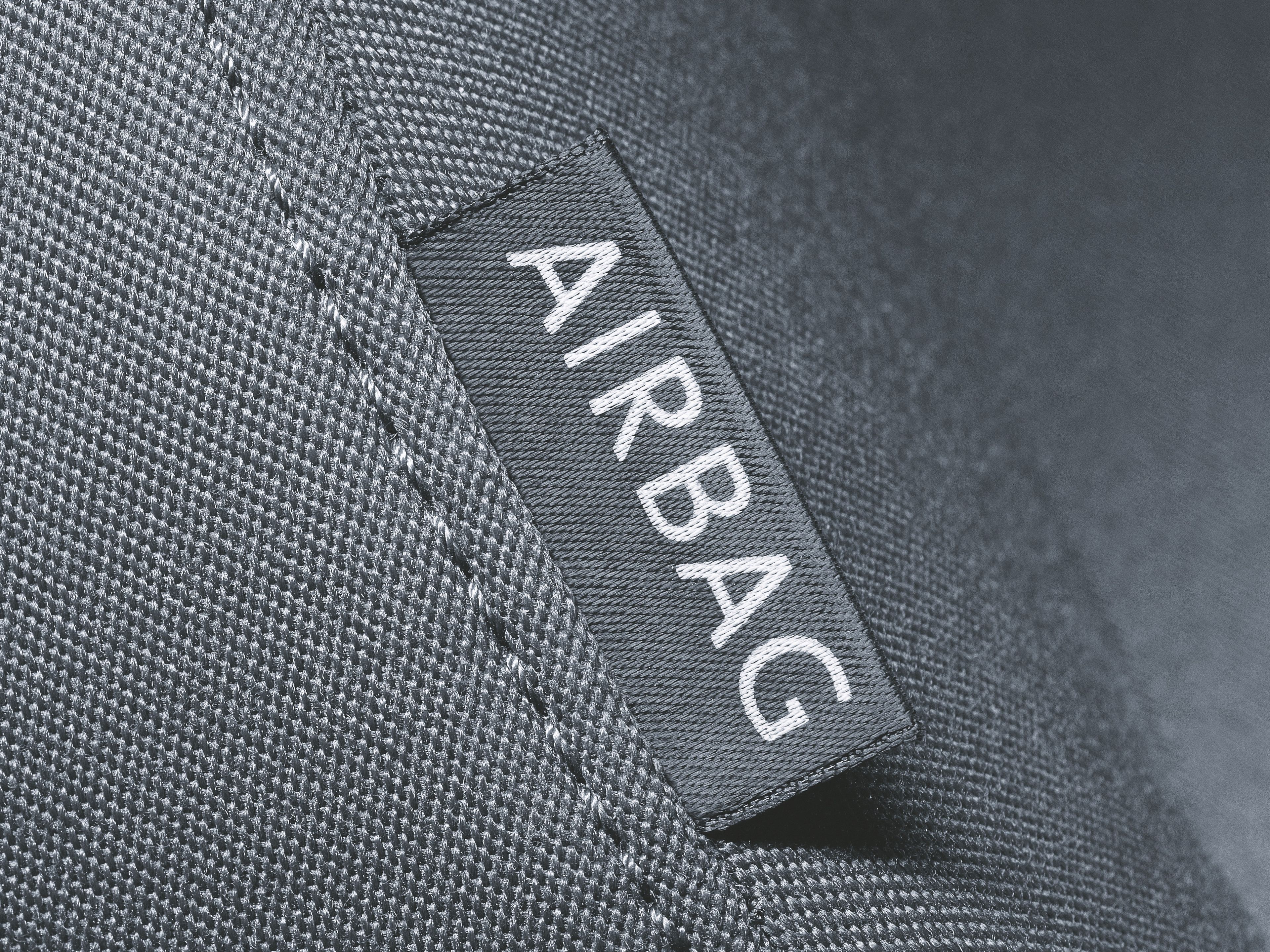 The close-up shot depicting a seat collar with an 'AIRBAG' tag.