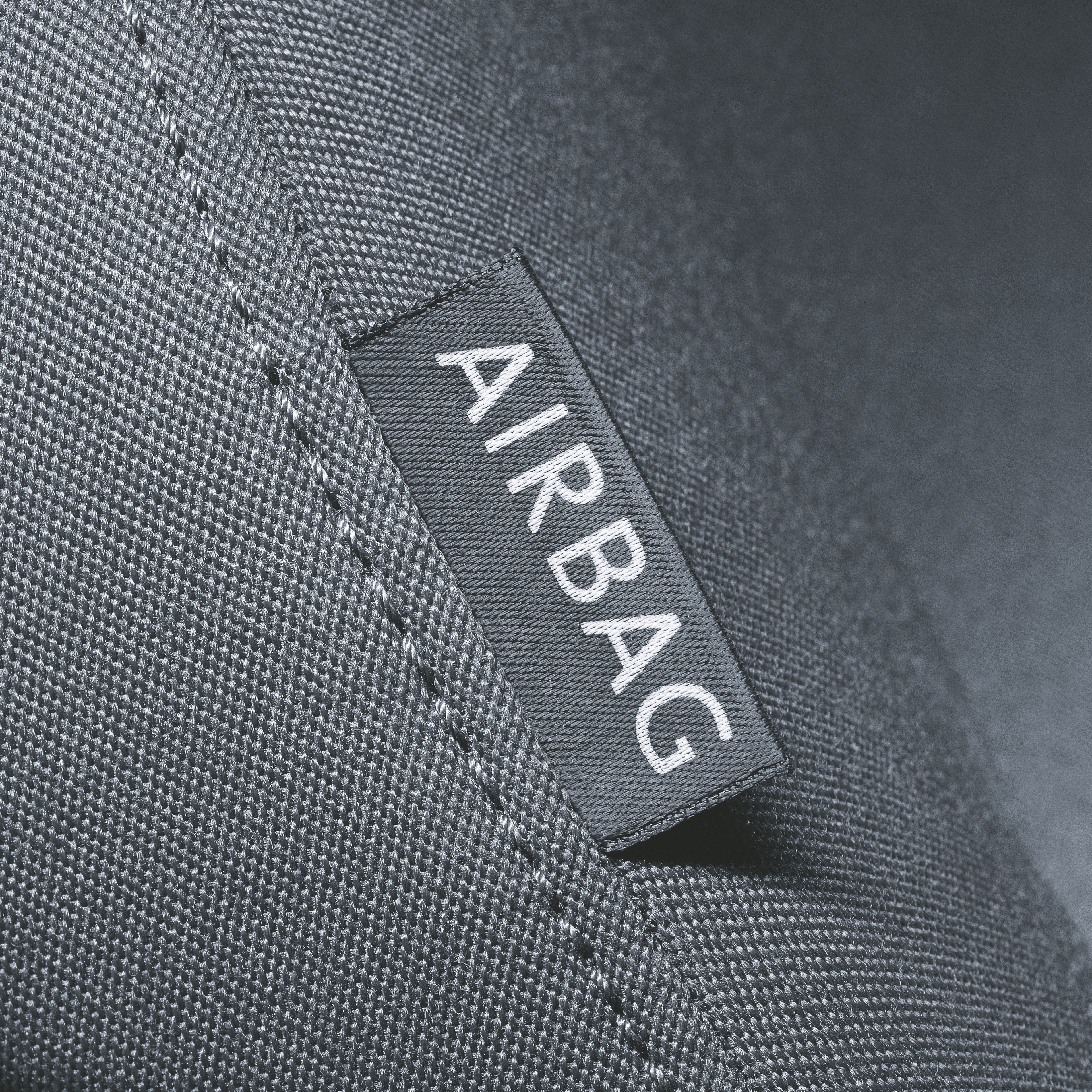 The close-up shot depicting a seat collar with an 'AIRBAG' tag.