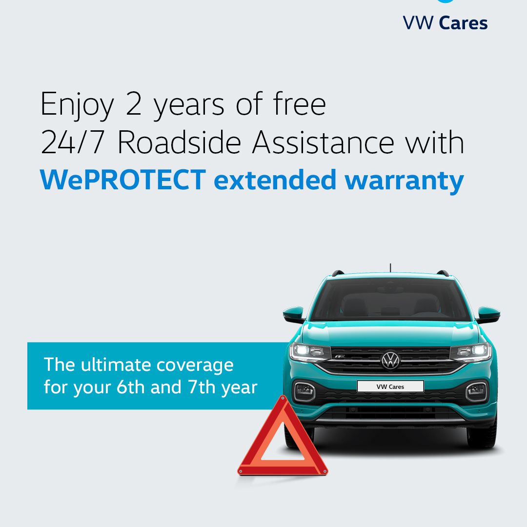 A teal Volkswagen with a roadside warning triangle
