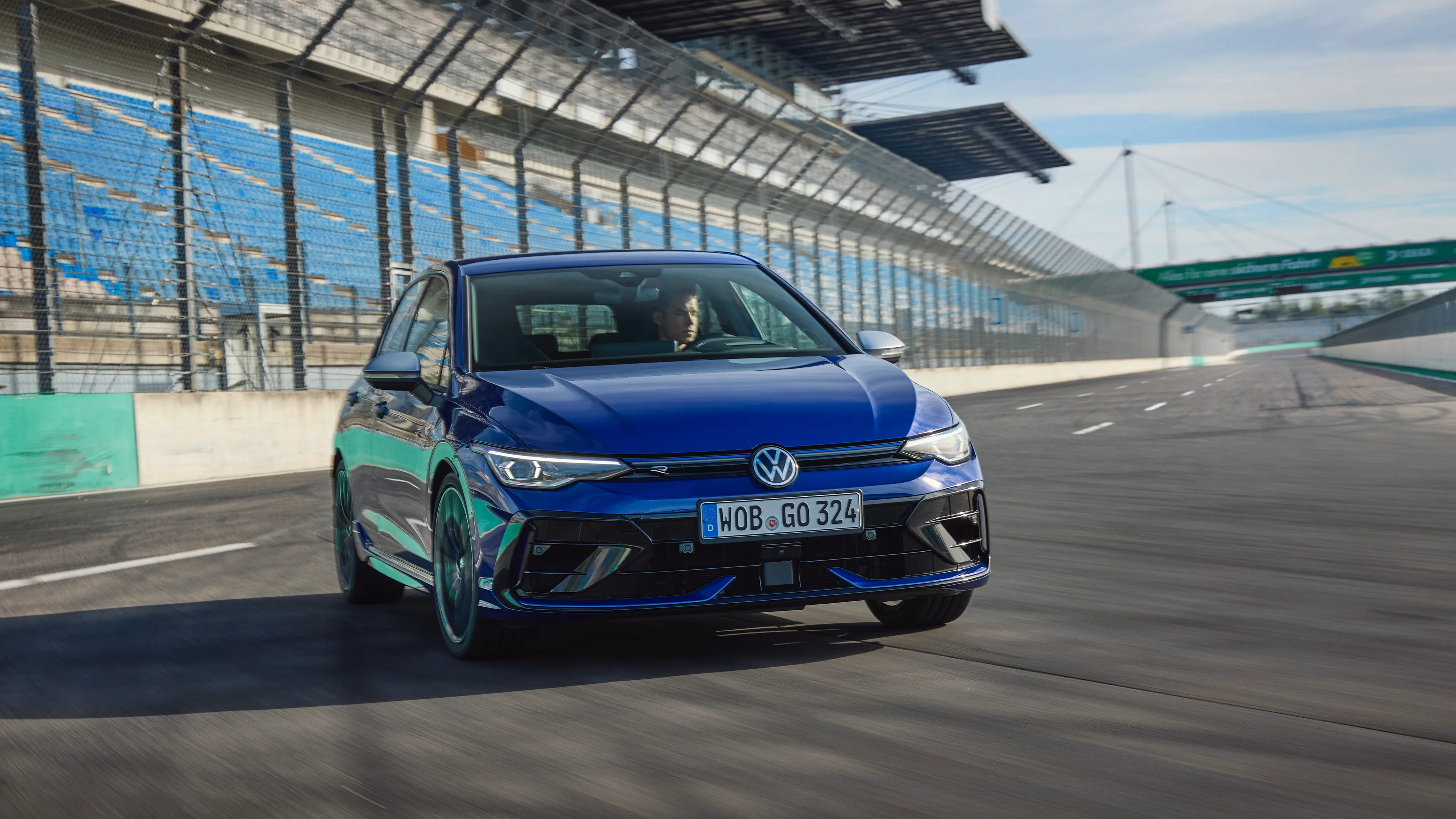 A blue Golf R drifting on a race track