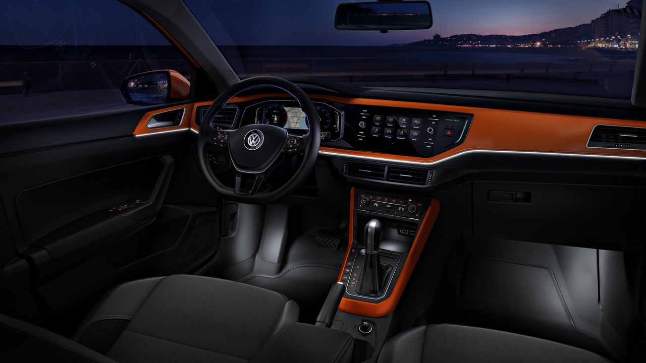 The look and feel of the interior of a Volkswagen vehicle with black and orange accents.
