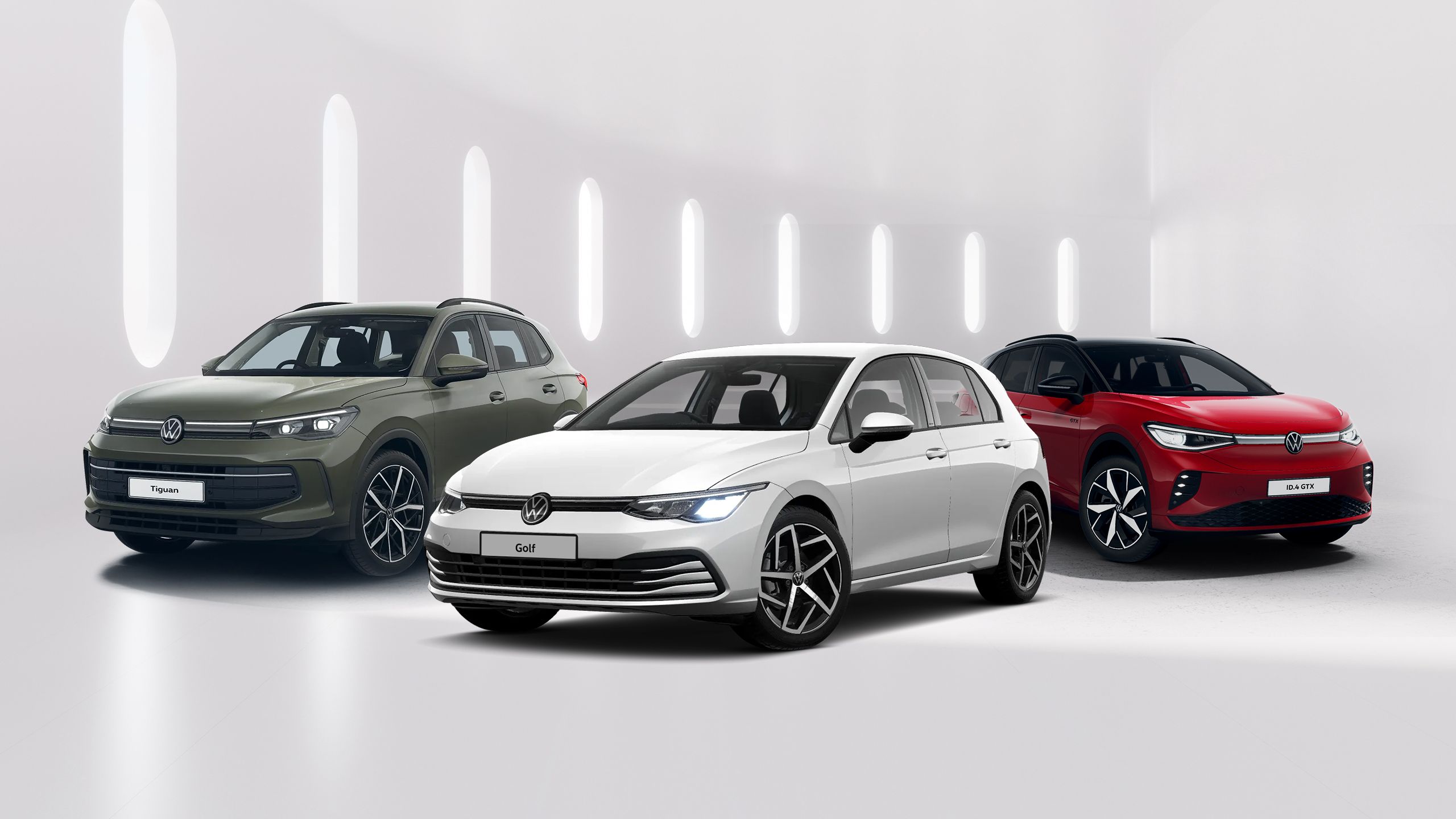 A white Volkswagen Golf, green Tiguan and red ID.4 GTX are displayed alongside each other against a minimalistic white background.