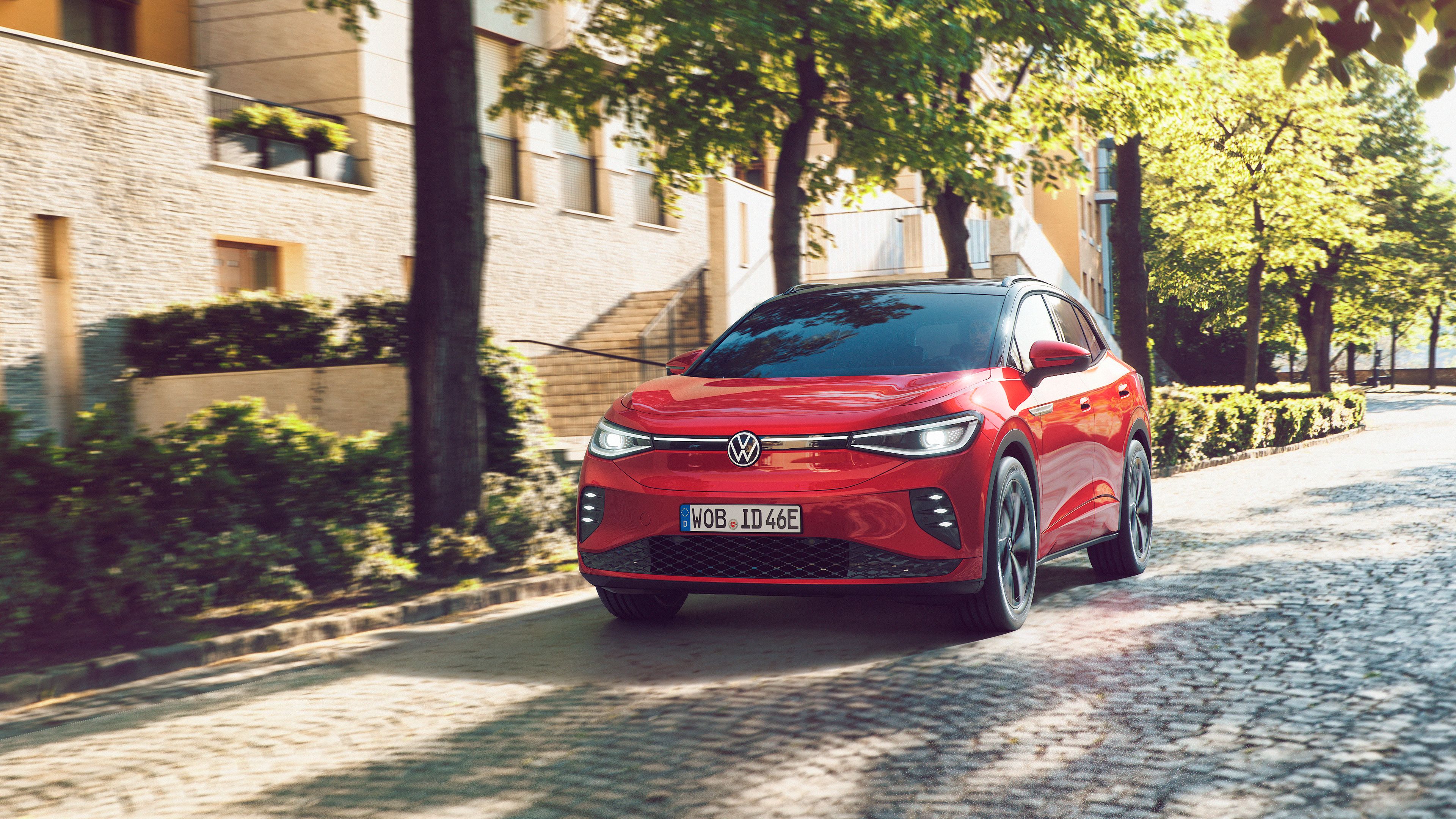 The Kings Red Volkswagen ID.4 GTX cruising down a cobblestone road