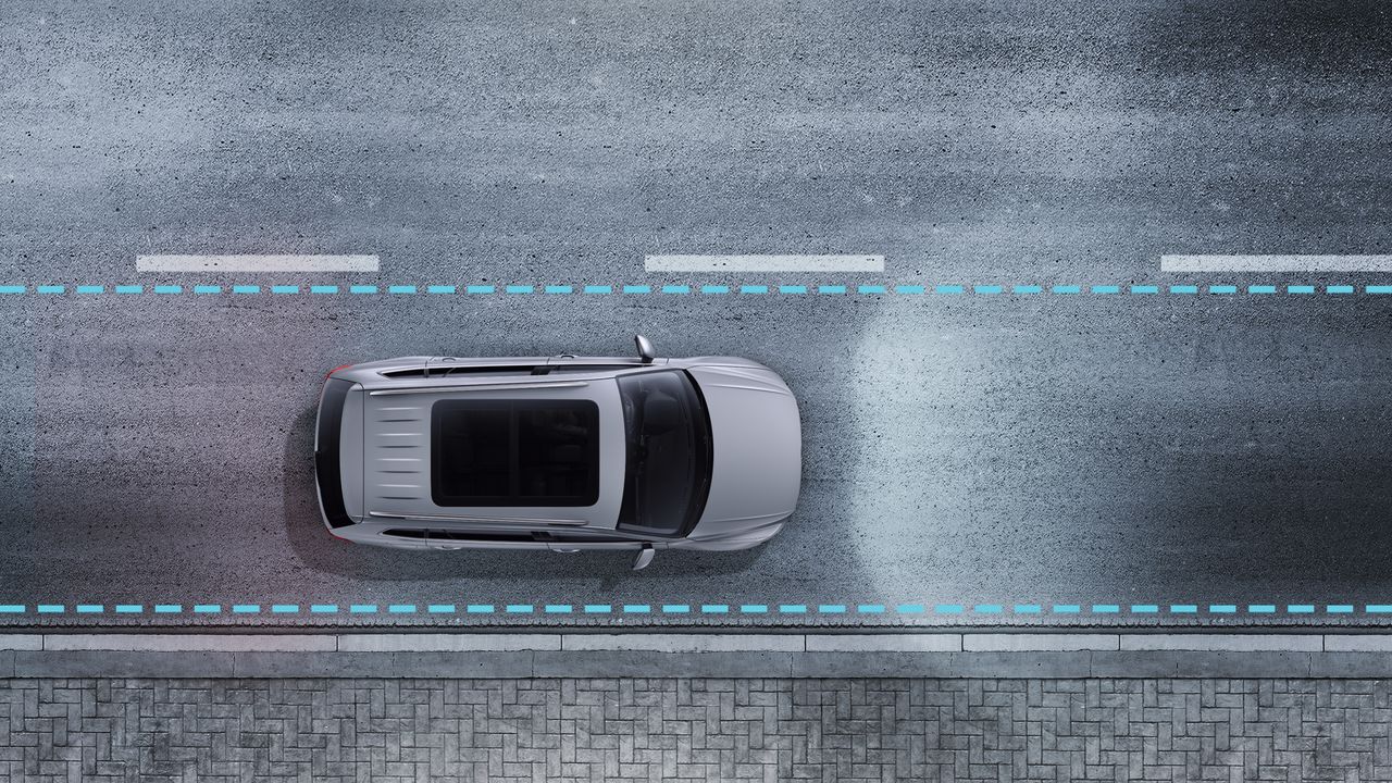 An image depicting Lane Assist being triggered to ensure the vehicle does not drift out of its lane.