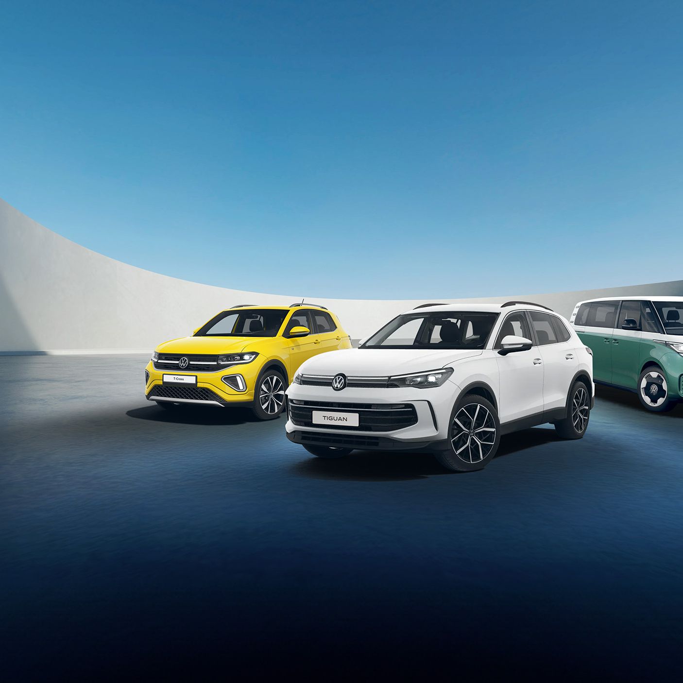 A white Tiguan, yellow T-Cross and candy white green ID. Buzz against a futuristic parking spot