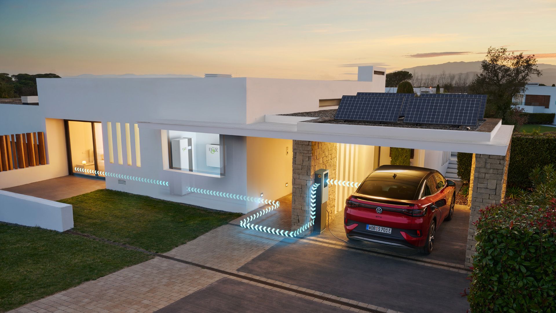 A red ID.5 GTX is charging while parked besides a modern house 