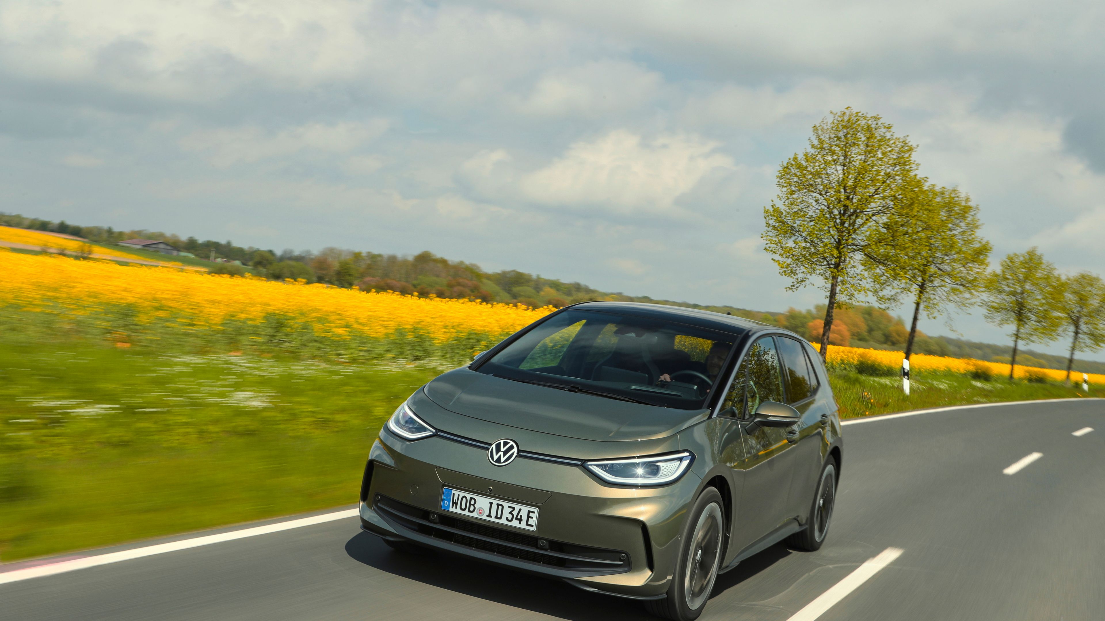 A metallic olive ID.3 cruising on the road