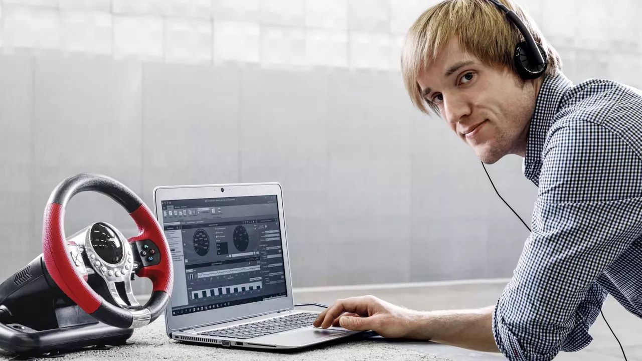 A carsound designer is touching on the laptop		
