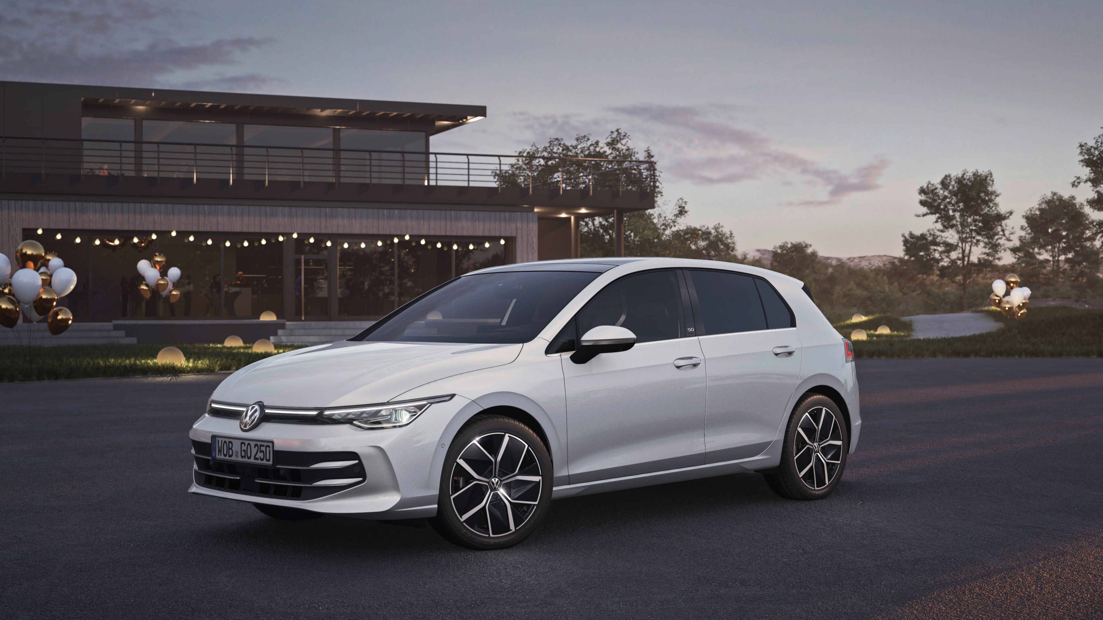 A white Volkswagen Golf parked on an open road at dusk.