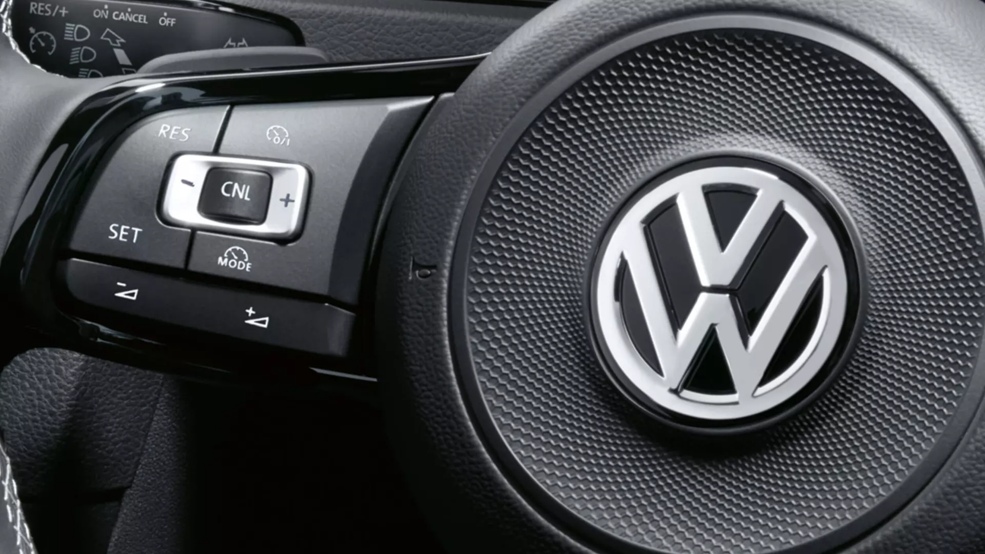 A close-up look on a Volkswagen vehicle steering wheel with digital clusters.