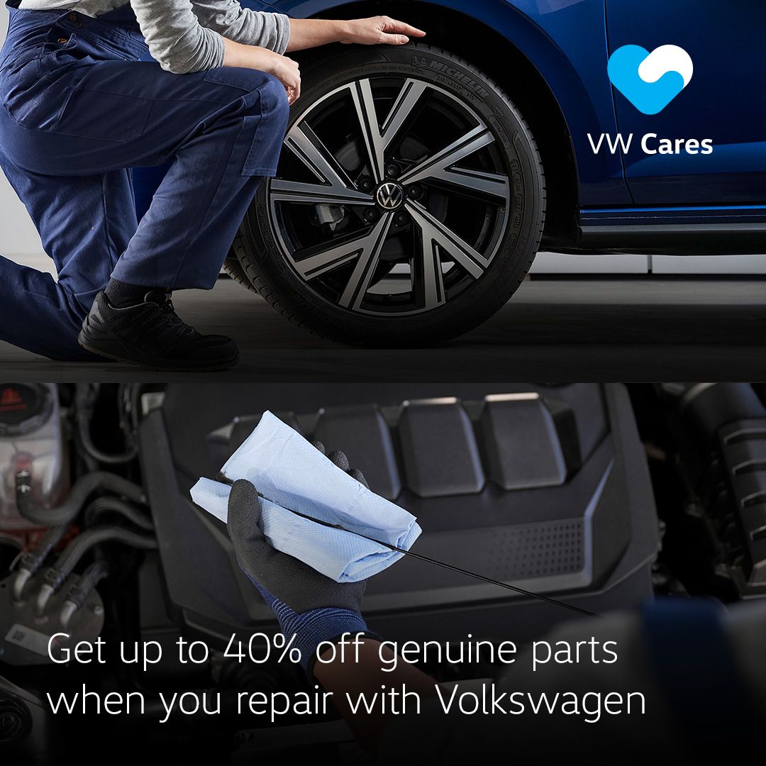 A close up of a Volkswagen tyre rim and a Volkswagen technician checking the engine oil