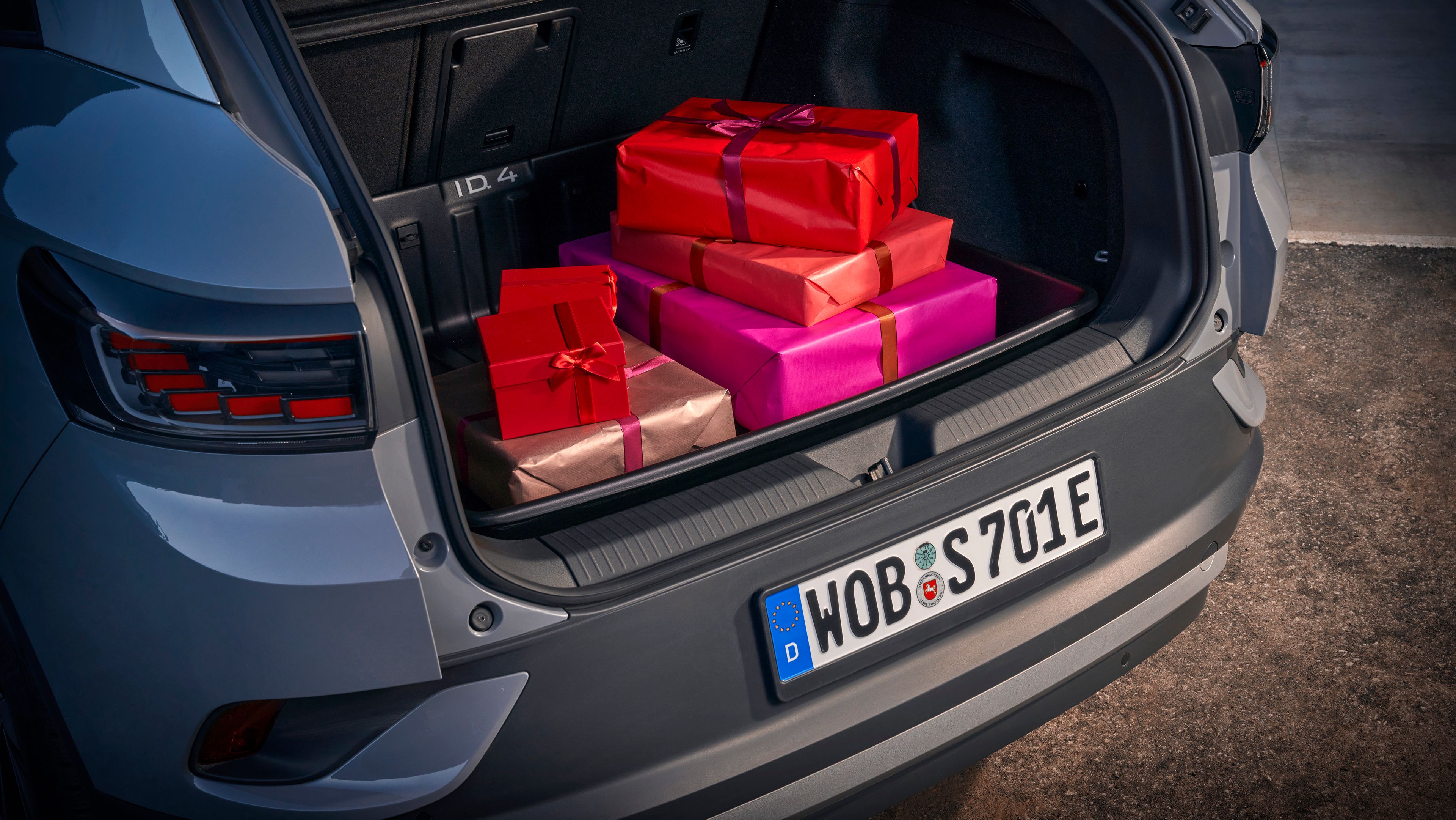 A car boot filled with perfectly wrapped presents of various shades of red