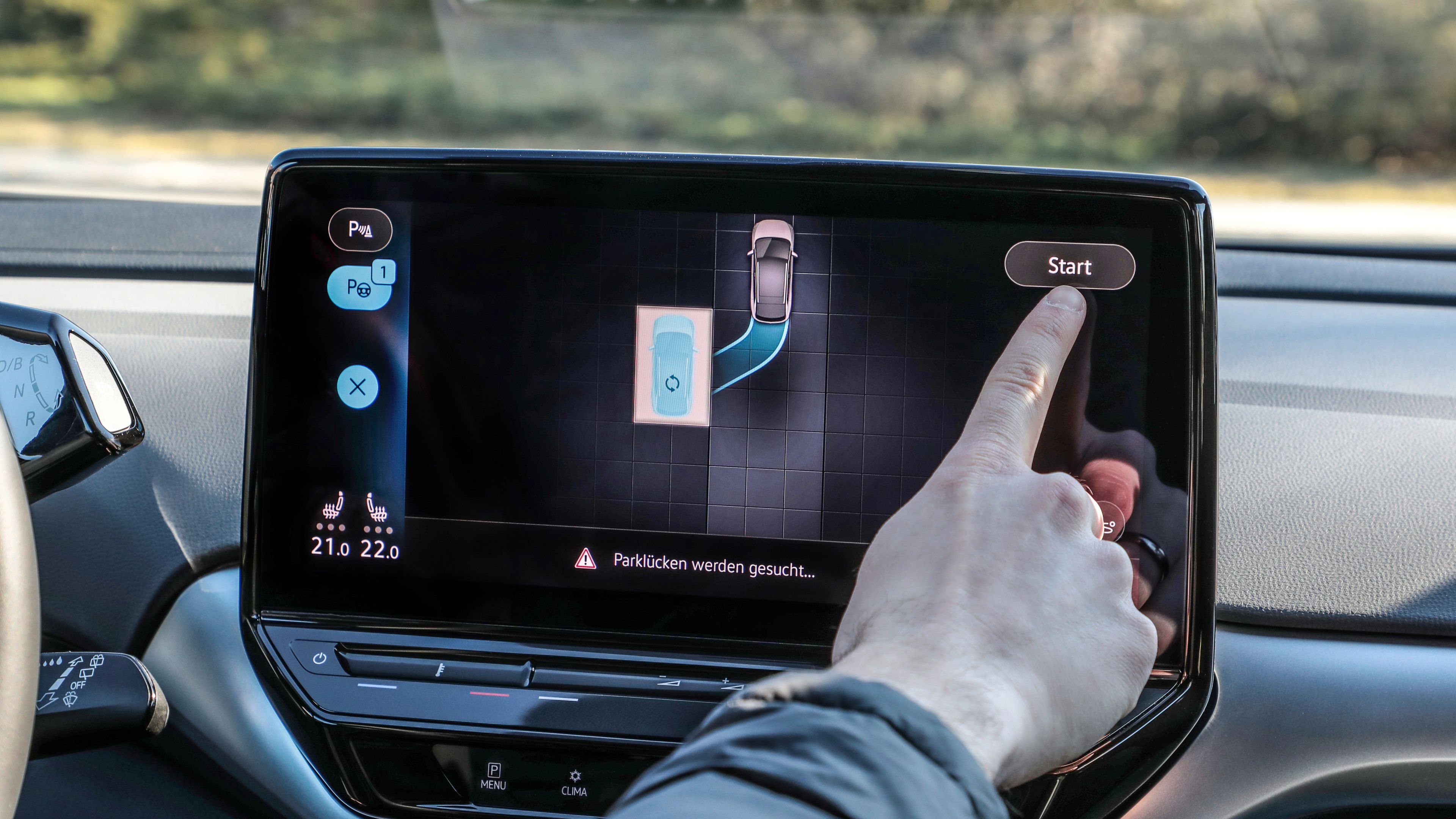 A guy pressing start on the touchscreen navigation system.