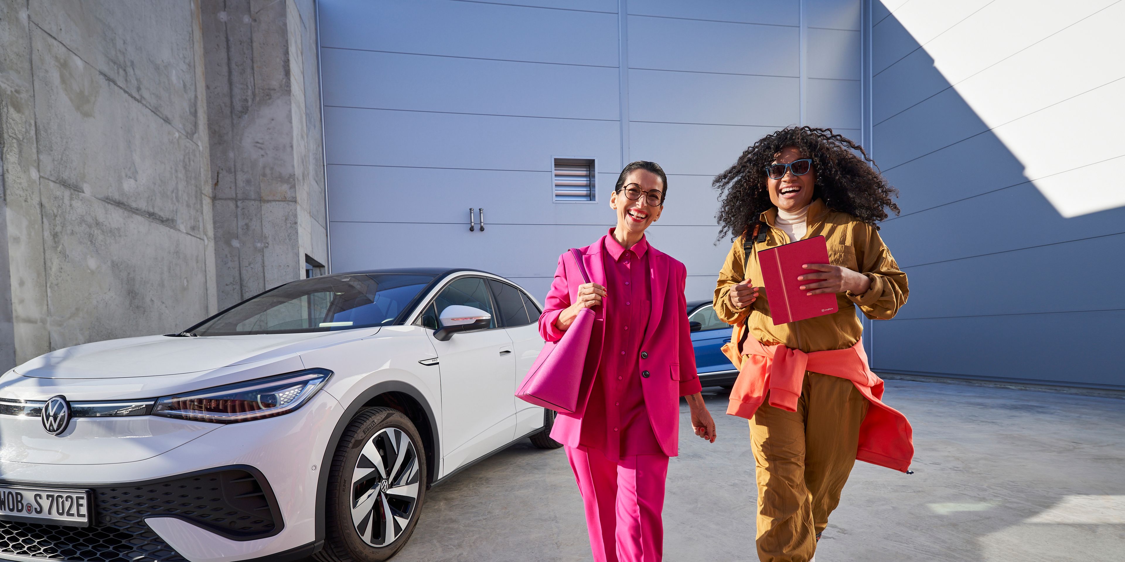 Two happy women in colourful outfit going about their day