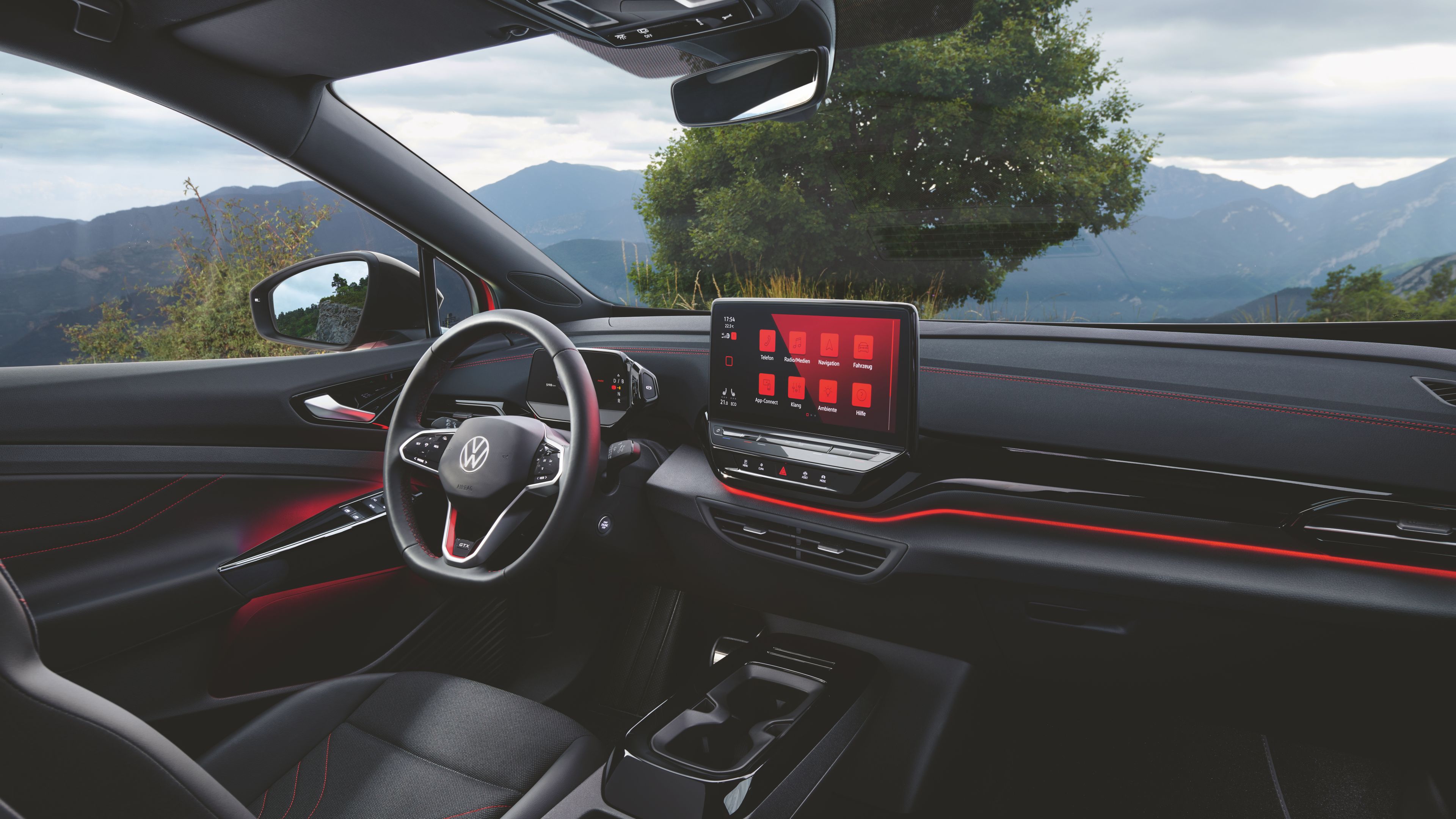 A wide, detailed view of the comfortable interior of the Volkswagen ID.5 GTX the steering wheel and innovative touch screen display 