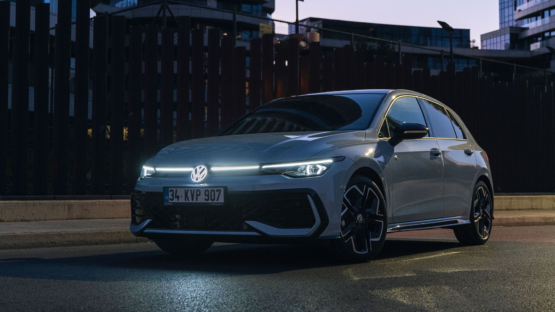 The new Golf R-Line parked with its lights on