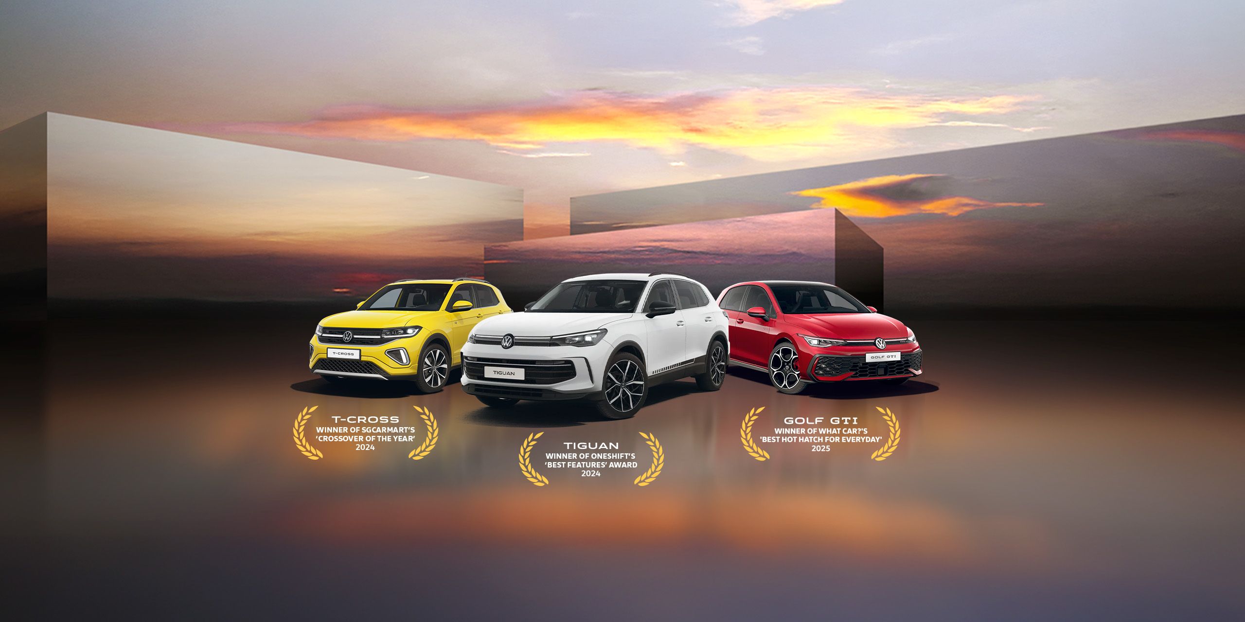 A yellow T-Cross, white Tiguan and red Golf GTI showcased against a beautiful sunset