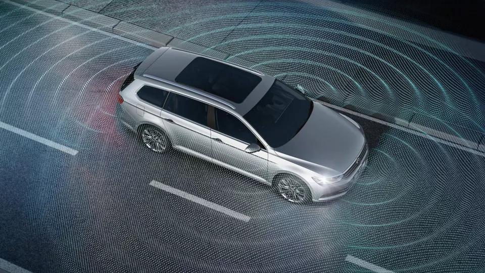An image depicting a silver Volkswagen vehicle triggering its parking sensors on the road.