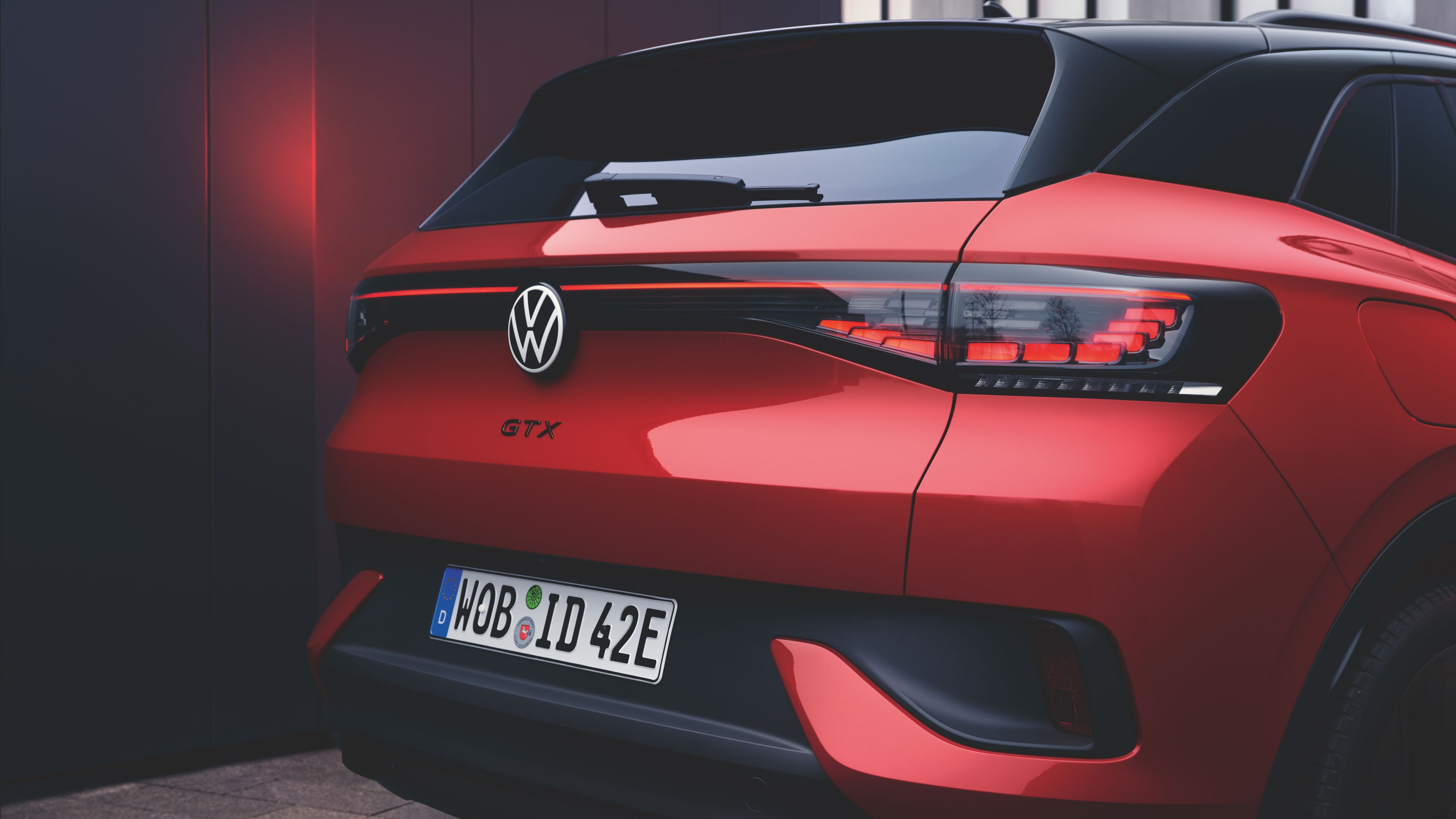 A back view of a parked Kings Red Premium Metallic Volkswagen ID.4.