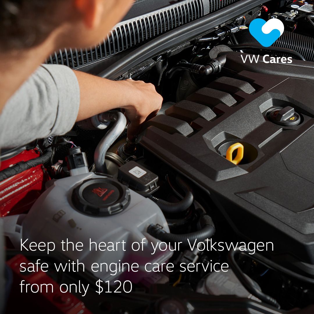 A Volkswagen technician checking the car engine