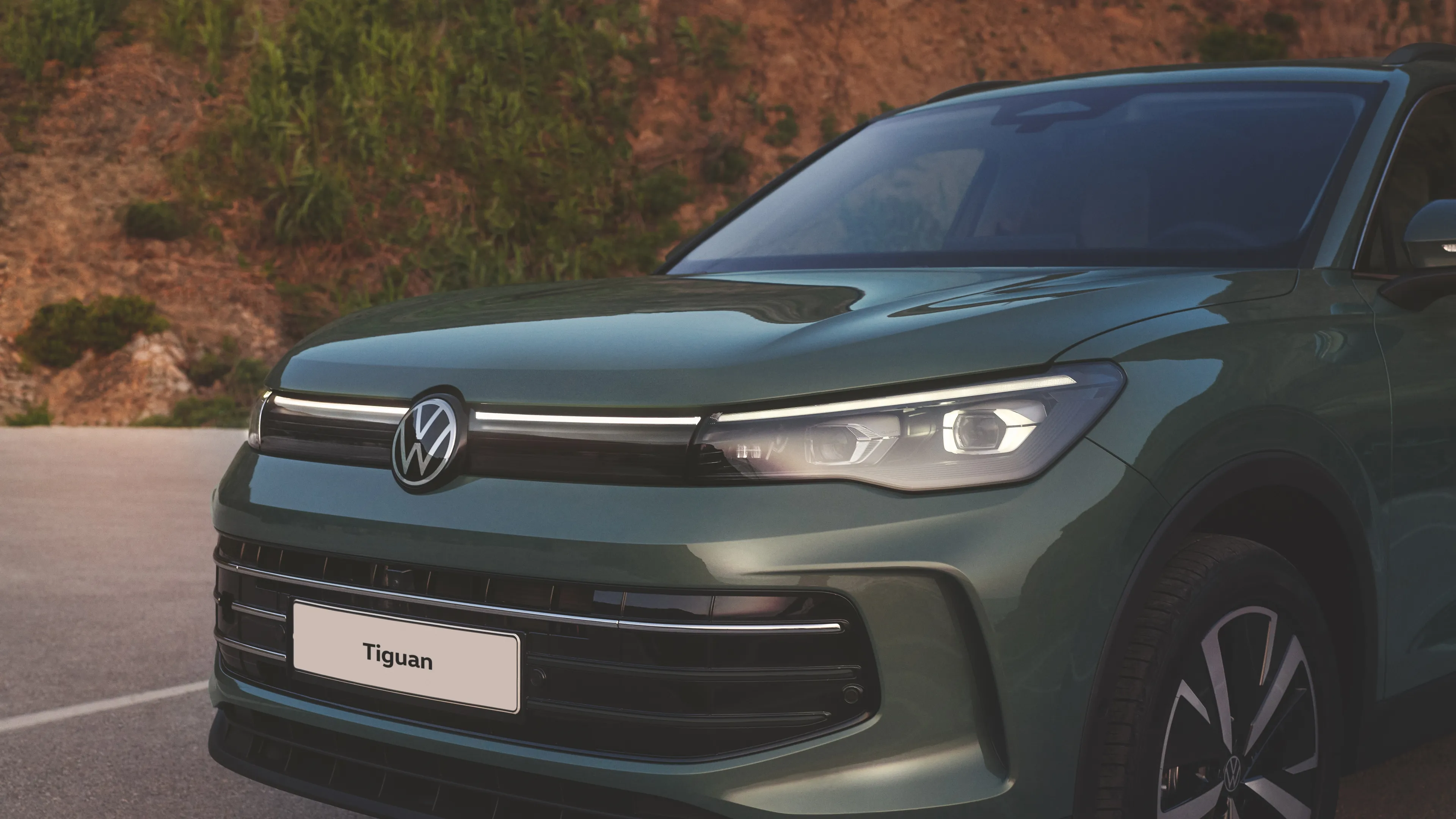 A close-up look of the front of a Volkswagen Tiguan on its distinctive IQ.Light HD Matrix headlights.