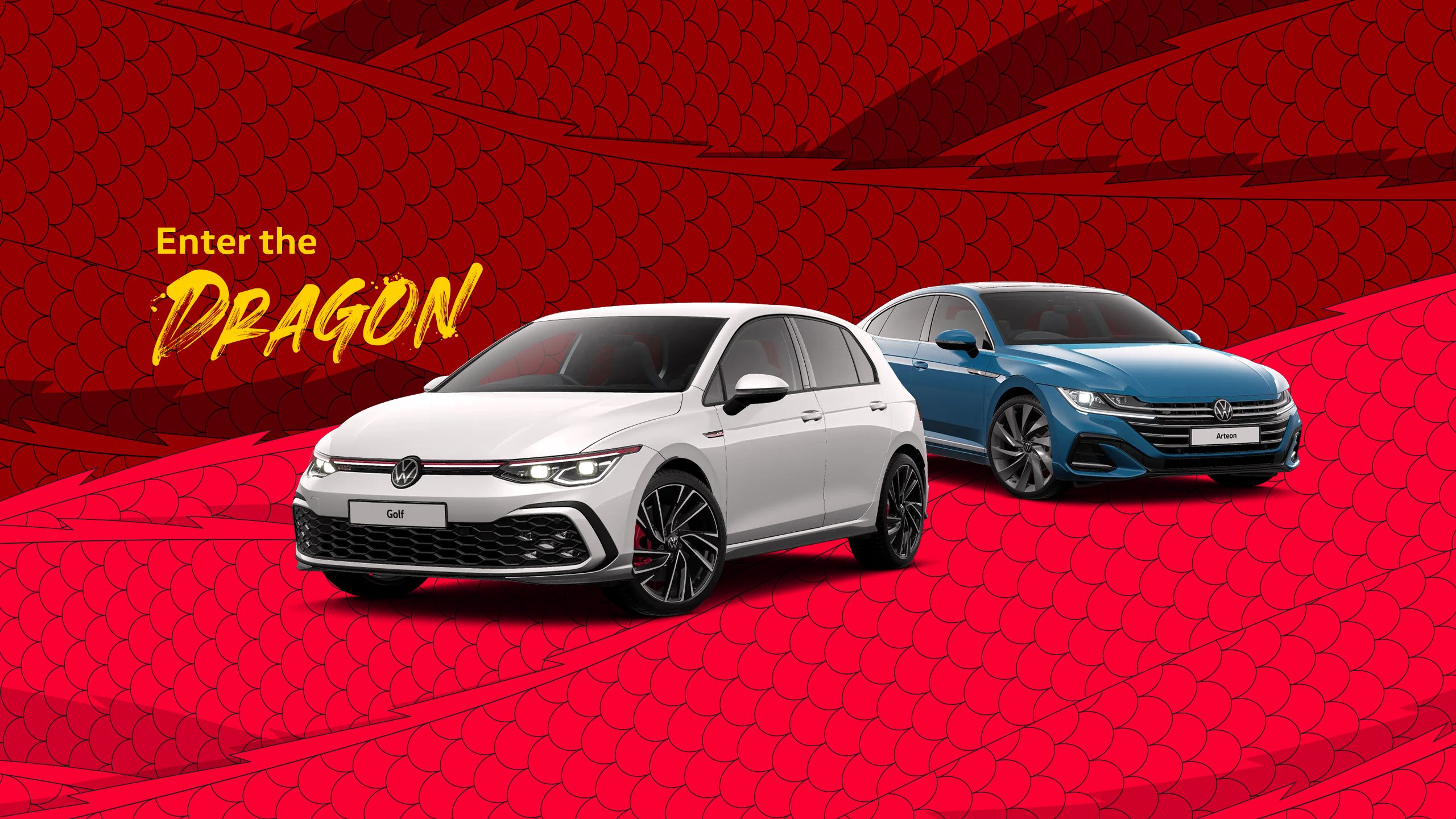 'Enter the Dragon' with two Volkswagen vehicles in front of a red backdrop with dragon scale decals