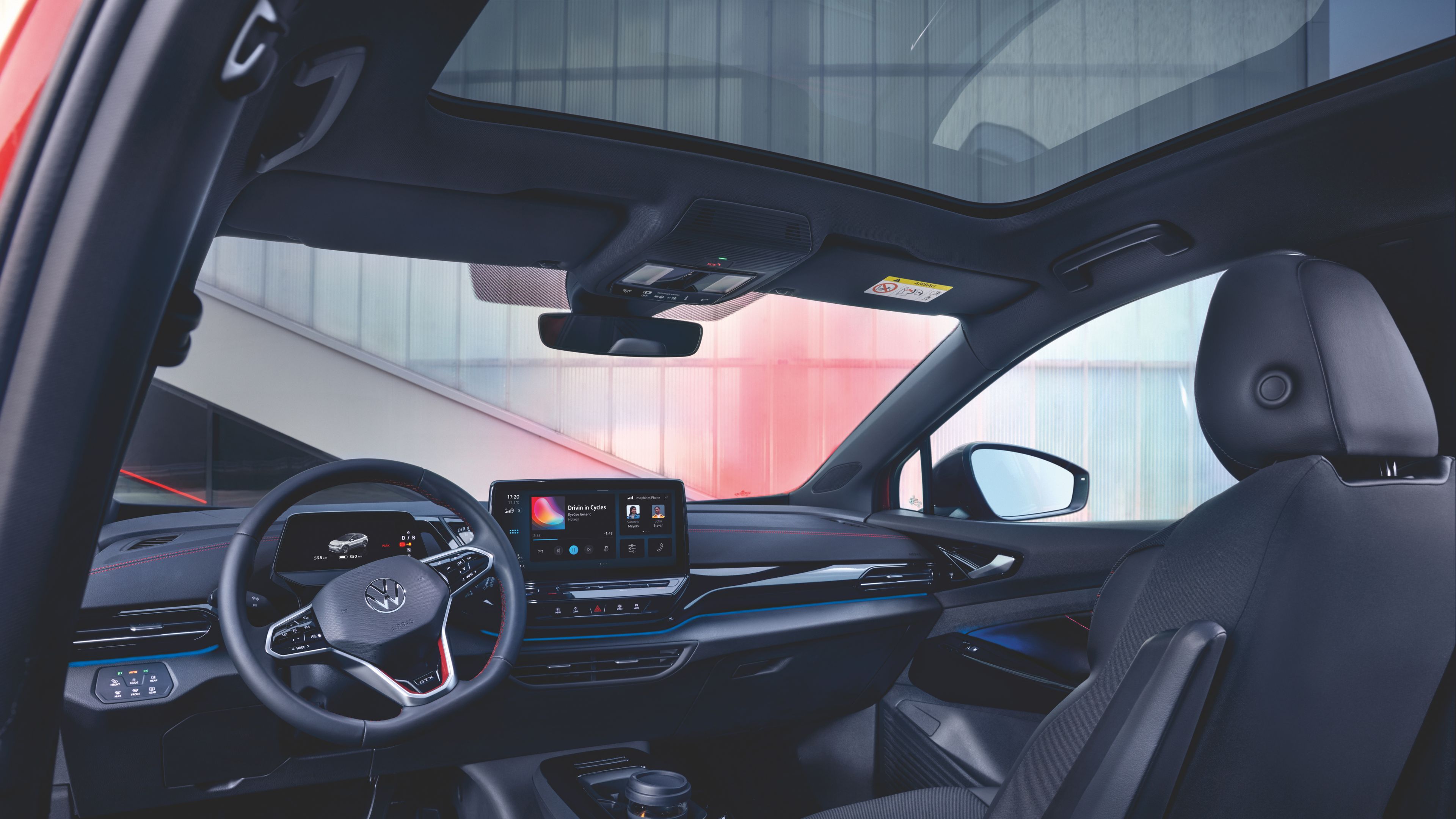 A wide, detailed view of the comfortable interior of the Volkswagen ID.4 GTX the steering wheel and innovative touch screen display.