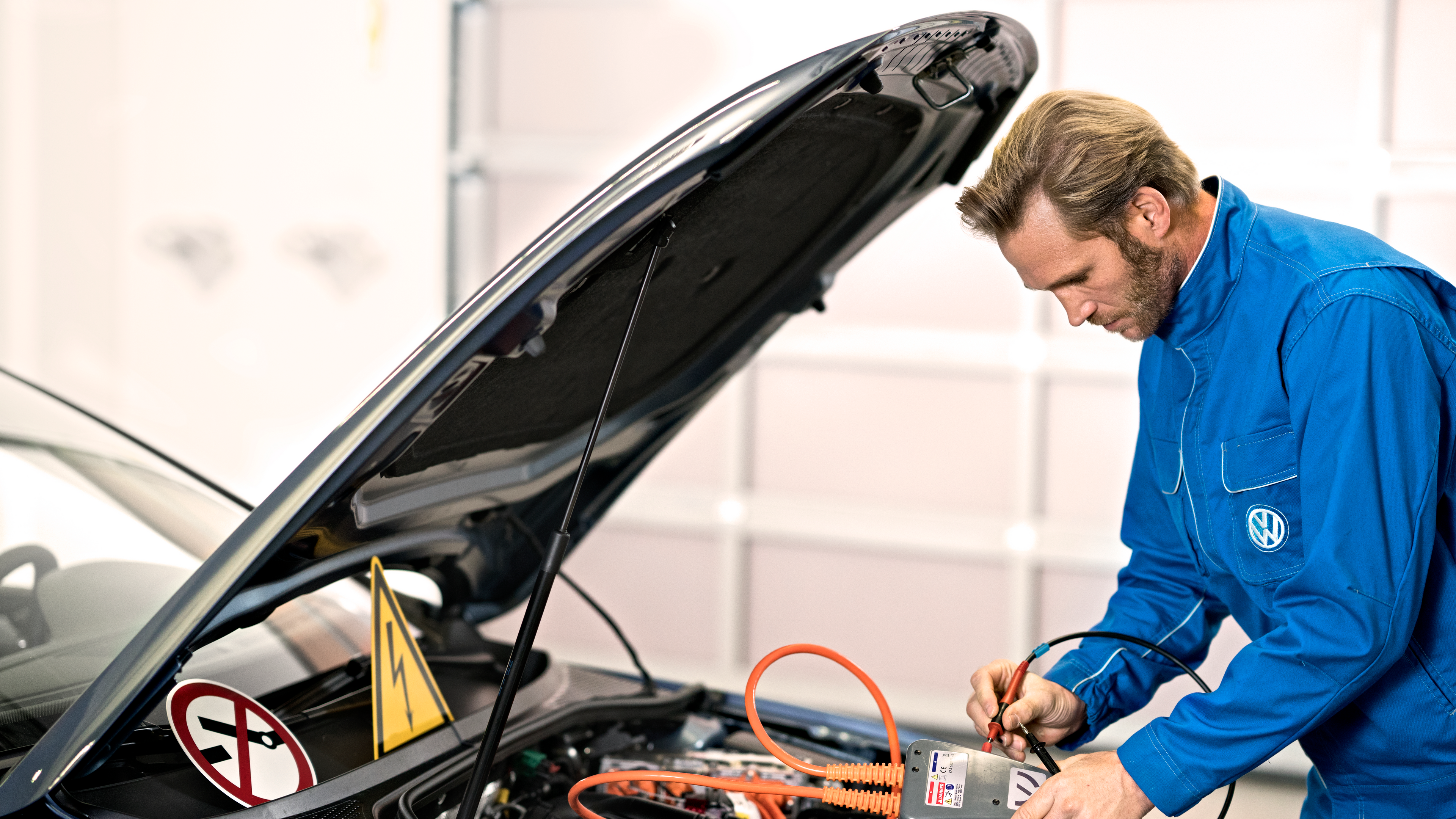 A Volkswagen certified technician checking the battery of the car