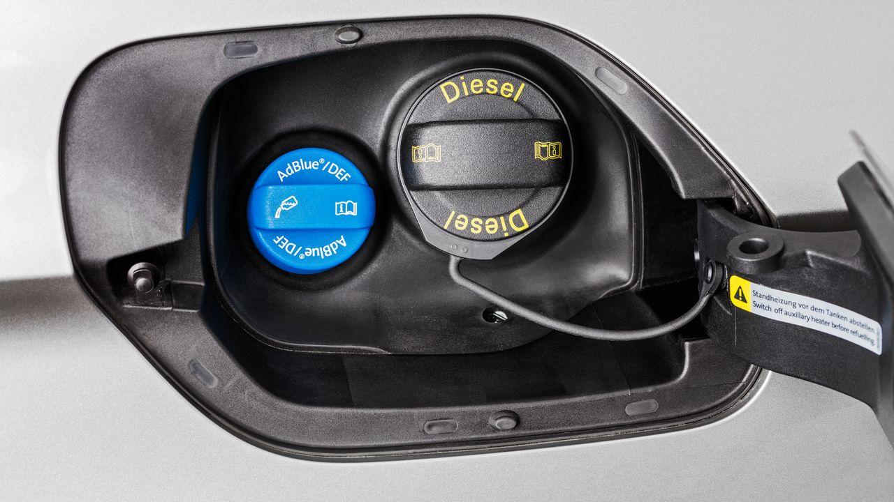 A close up view of a Volkswagen vehicle's fuel and AdBlue hatch when opened.