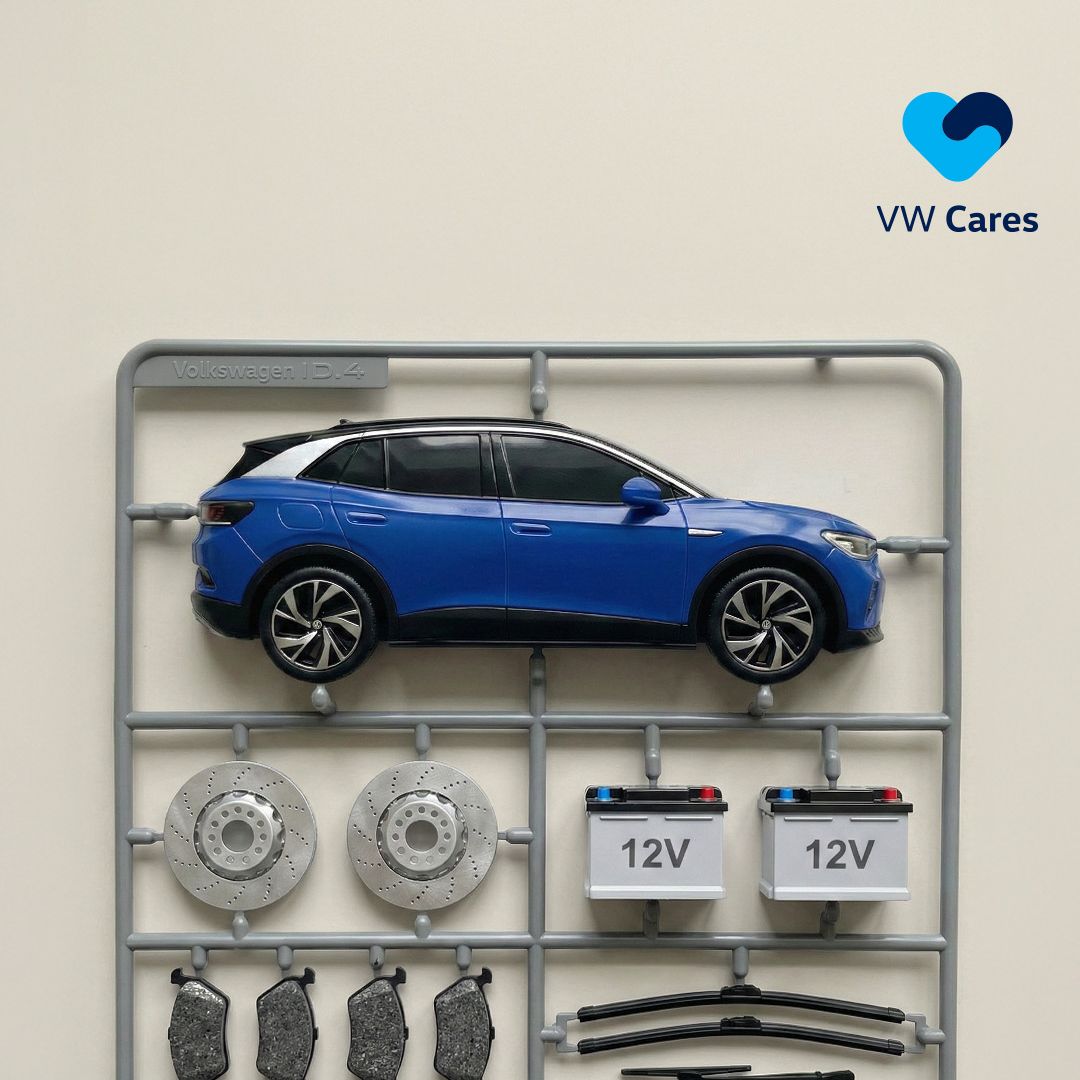 A blue electric vehicle laid out with its parts